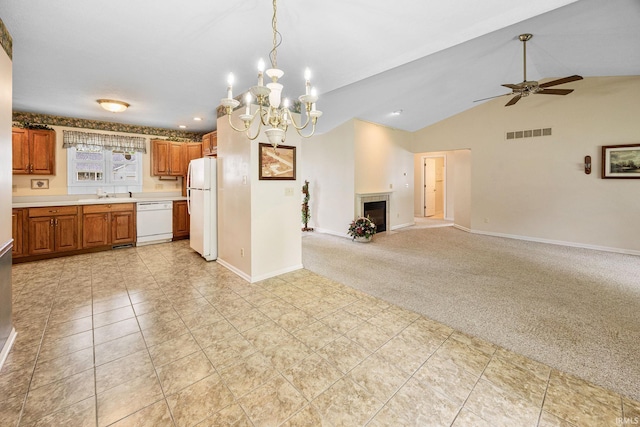 kitchen featuring white appliances, light countertops, a chandelier, brown cabinetry, and a ceiling fan