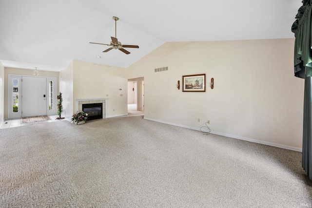 unfurnished living room with a ceiling fan, a tiled fireplace, baseboards, high vaulted ceiling, and carpet flooring