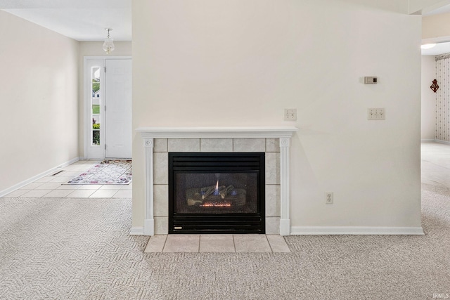 detailed view of carpet floors, a fireplace, and baseboards