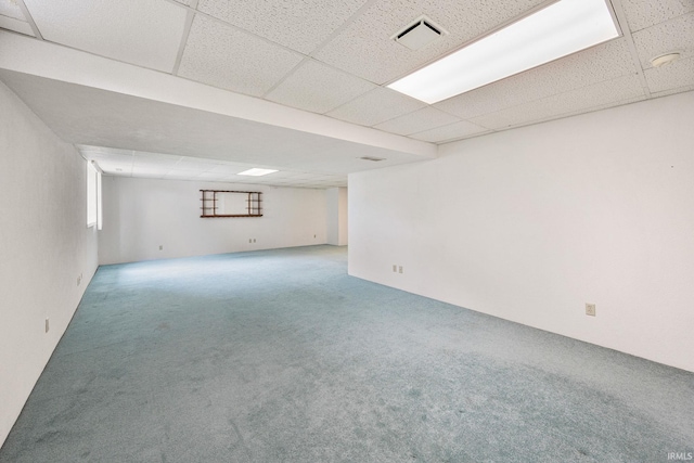 basement with carpet floors and a drop ceiling