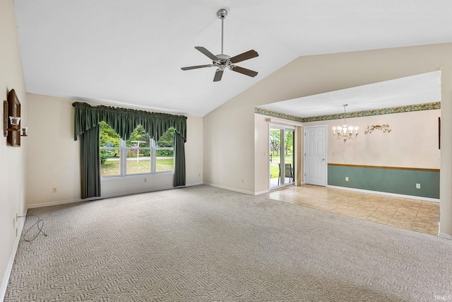 carpeted spare room featuring a chandelier, ceiling fan, baseboards, and high vaulted ceiling