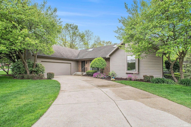16166 Candlewycke Ct, Granger, IN 46530 - view of front facade featuring concrete driveway, an attached garage, a front yard, and brick siding