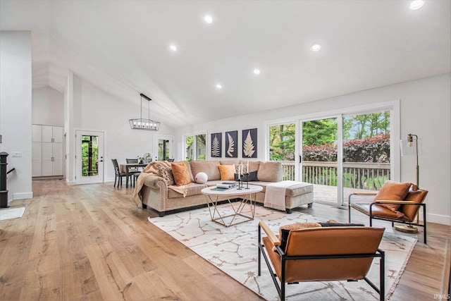 16166 Candlewycke Ct, Granger, IN 46530 - living room featuring light wood-type flooring, healthy amount of natural light, high vaulted ceiling, recessed lighting, and a chandelier
