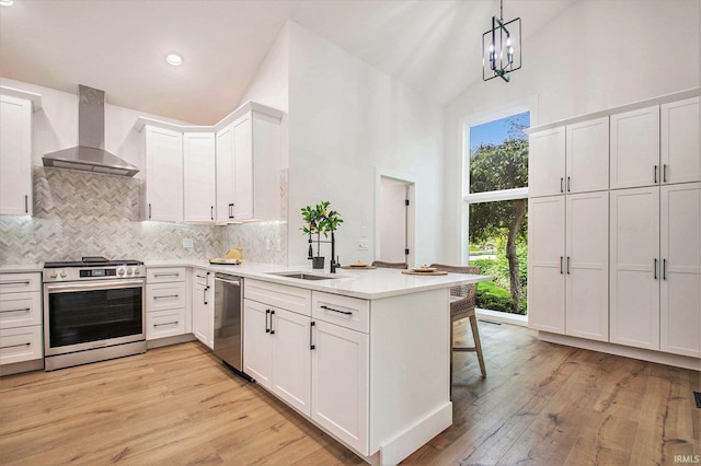 16166 Candlewycke Ct, Granger, IN 46530 - kitchen with stainless steel appliances, wall chimney exhaust hood, a sink, high vaulted ceiling, and decorative backsplash