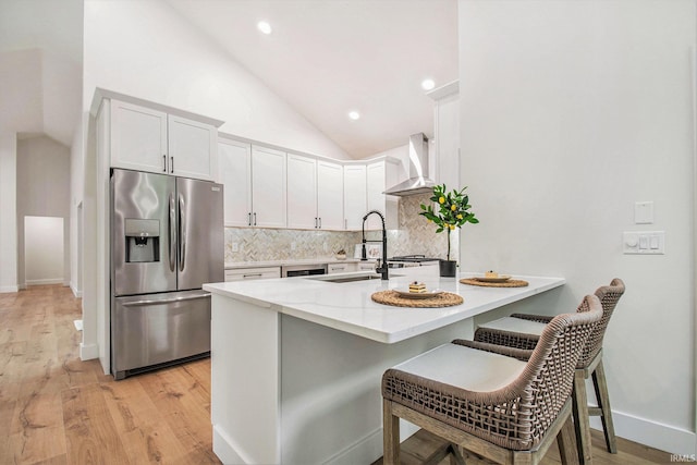 16166 Candlewycke Ct, Granger, IN 46530 - kitchen featuring stainless steel refrigerator with ice dispenser, wall chimney range hood, vaulted ceiling, tasteful backsplash, and a sink