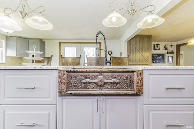 11009 S County Road 300 W, Muncie, IN 47302 - kitchen with a chandelier, light stone countertops, and white cabinets