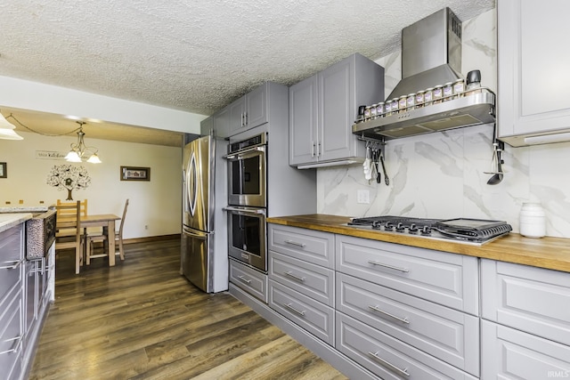 11009 S County Road 300 W, Muncie, IN 47302 - kitchen with stainless steel appliances, wall chimney range hood, butcher block counters, gray cabinetry, and dark wood-style flooring