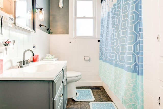 1409 Main St, Vincennes, IN 47591 - bathroom with tile walls, toilet, vanity, and a shower with shower curtain
