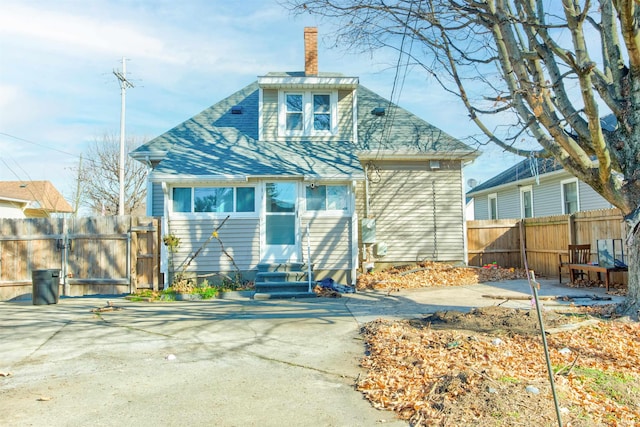 1409 Main St, Vincennes, IN 47591 - rear view of property with entry steps, a gate, fence, and a chimney