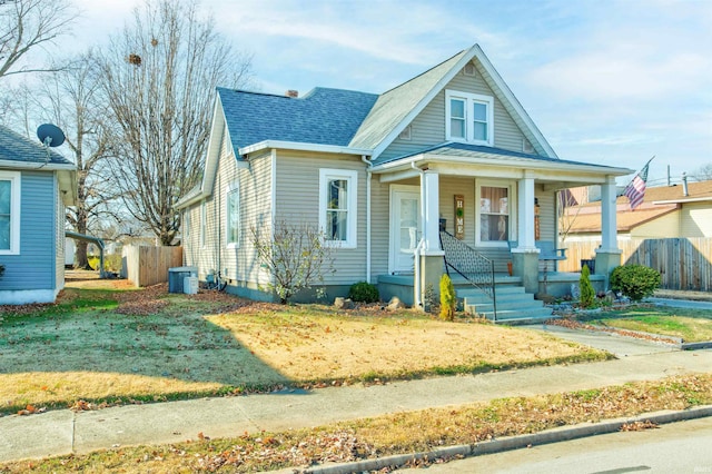 1409 Main St, Vincennes, IN 47591 - bungalow-style house featuring a porch, fence, central air condition unit, and a shingled roof