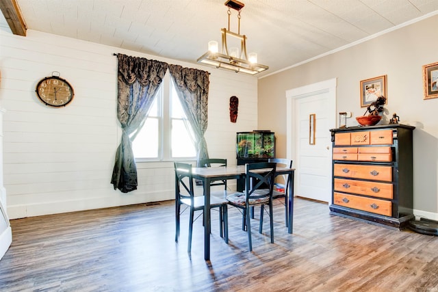 1409 Main St, Vincennes, IN 47591 - dining area with wood finished floors, a chandelier, wooden walls, and ornamental molding