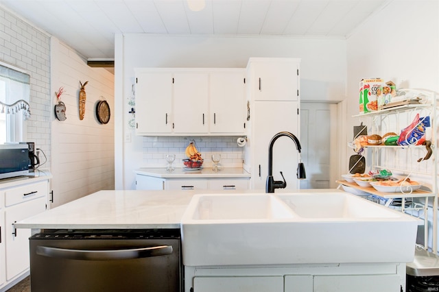 1409 Main St, Vincennes, IN 47591 - kitchen featuring stainless steel appliances, backsplash, a sink, light countertops, and white cabinetry