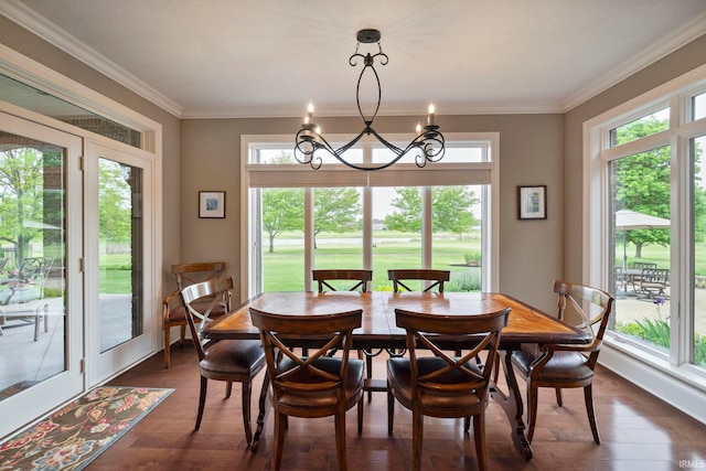 5198 Gardenia Ct, West Lafayette, IN 47906 - dining room featuring plenty of natural light, a chandelier, dark wood-style floors, and ornamental molding