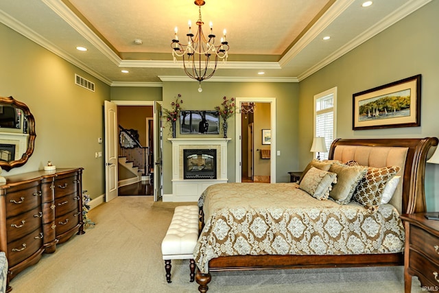 5198 Gardenia Ct, West Lafayette, IN 47906 - bedroom featuring a tiled fireplace, a chandelier, light colored carpet, a raised ceiling, and crown molding