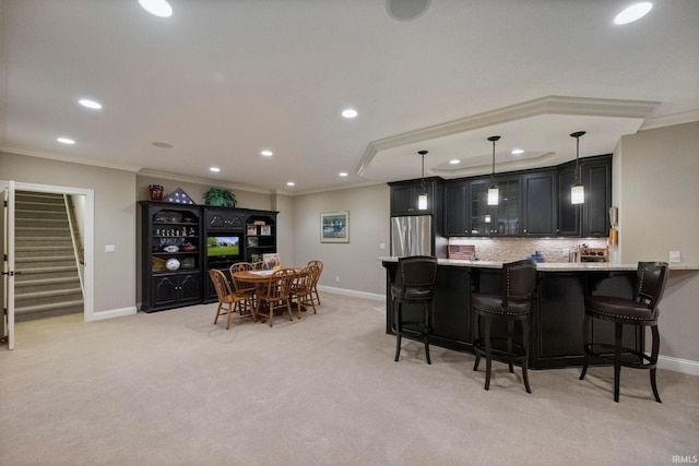 5198 Gardenia Ct, West Lafayette, IN 47906 - kitchen with stainless steel fridge, recessed lighting, a breakfast bar area, baseboards, and crown molding