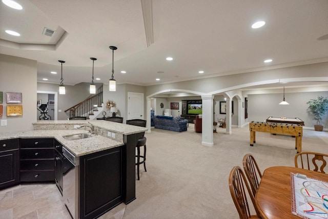 5198 Gardenia Ct, West Lafayette, IN 47906 - kitchen with a sink, ornate columns, arched walkways, dark cabinets, and recessed lighting