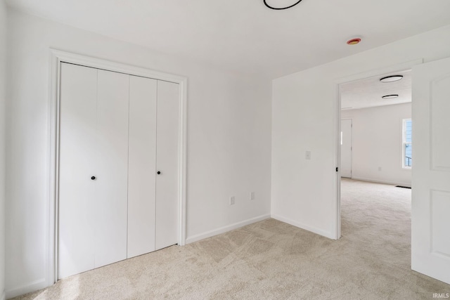 516 W Pike St, Warsaw, IN 46580 - unfurnished bedroom featuring light carpet, a closet, and baseboards