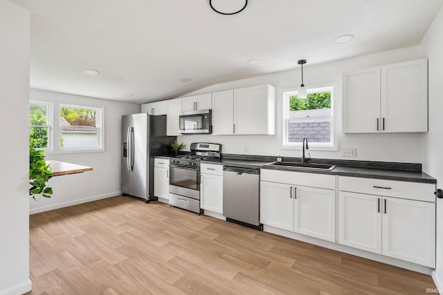 516 W Pike St, Warsaw, IN 46580 - kitchen with stainless steel appliances, a sink, dark countertops, plenty of natural light, and lofted ceiling