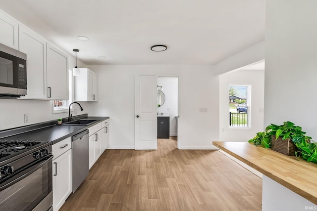 516 W Pike St, Warsaw, IN 46580 - kitchen with a sink, appliances with stainless steel finishes, plenty of natural light, and light wood-style flooring