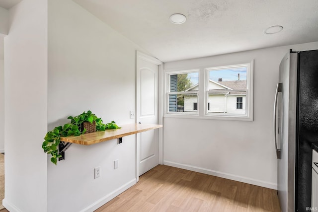 516 W Pike St, Warsaw, IN 46580 - interior space featuring light wood-style floors and baseboards