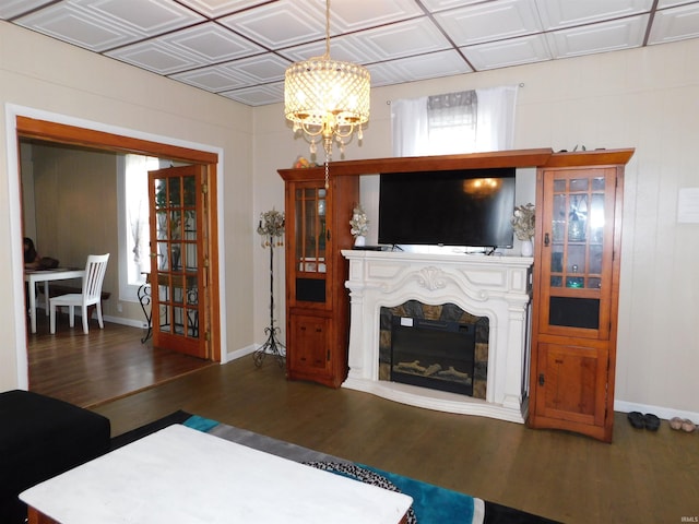 418 Watt St, Jeffersonville, IN 47130 - living area featuring wood finished floors, a chandelier, baseboards, a glass covered fireplace, and an ornate ceiling
