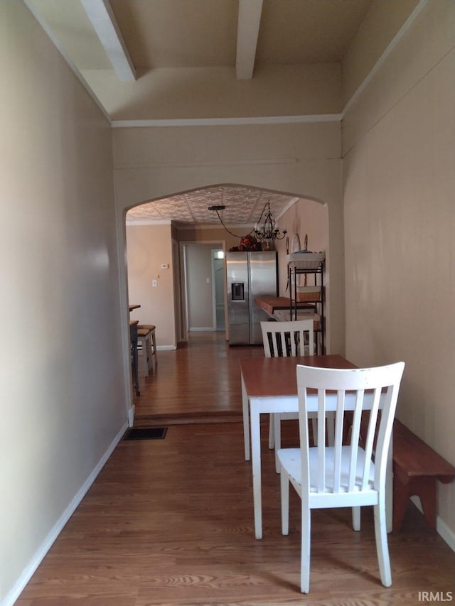 418 Watt St, Jeffersonville, IN 47130 - dining room with wood finished floors, arched walkways, baseboards, and beam ceiling