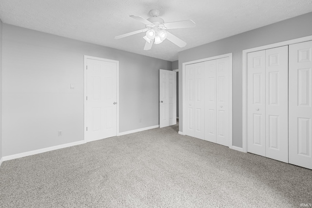 541 Genevieve Ave, Jasper, IN 47546 - unfurnished bedroom with multiple closets, carpet floors, baseboards, a textured ceiling, and a ceiling fan