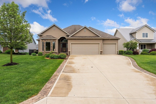 traditional home featuring a garage, driveway, and a front lawn