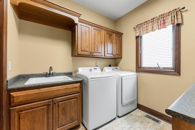 laundry room with cabinet space, washer and dryer, and baseboards