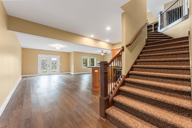 stairs with wood finished floors, baseboards, french doors, a ceiling fan, and recessed lighting