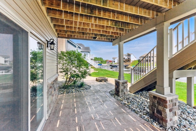 view of patio featuring an outdoor fire pit and stairs