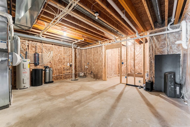 unfinished basement with electric water heater and a water softener