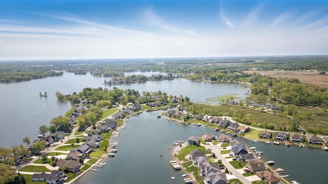 view of property location featuring a nearby body of water and nearby suburban area