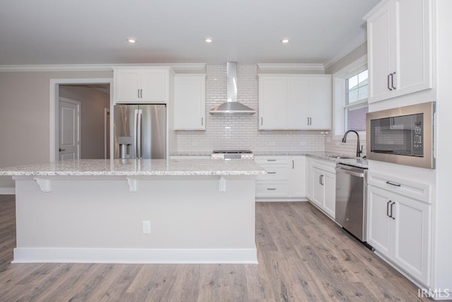 6968 Barlow Ct, Newburgh, IN 47630 - kitchen featuring appliances with stainless steel finishes, wall chimney exhaust hood, a center island, a sink, and crown molding