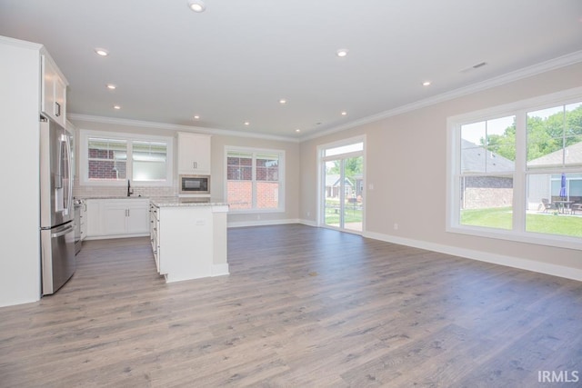 6968 Barlow Ct, Newburgh, IN 47630 - kitchen featuring stainless steel fridge with ice dispenser, a sink, crown molding, open floor plan, and built in microwave