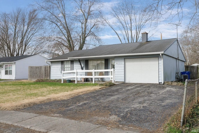 5621 Council Ring Blvd, Kokomo, IN 46902 - single story home featuring a chimney, driveway, fence, central AC unit, and a garage