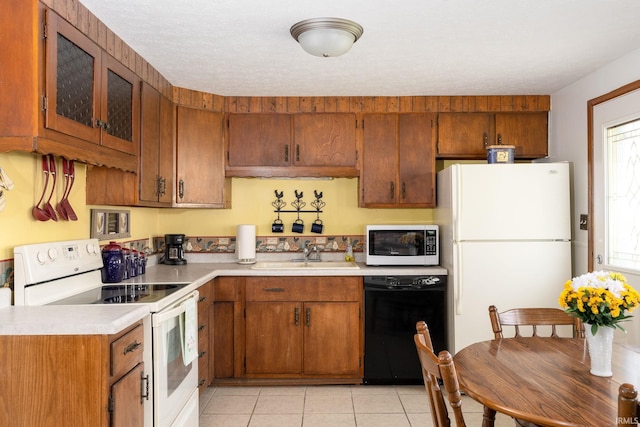 5621 Council Ring Blvd, Kokomo, IN 46902 - kitchen featuring white appliances, light countertops, a sink, and brown cabinets