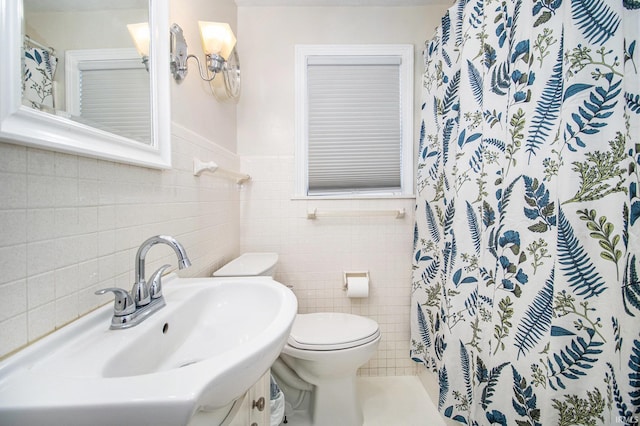 423 N Esther St, South Bend, IN 46617 - full bathroom with a sink, tile walls, toilet, curtained shower, and a wainscoted wall