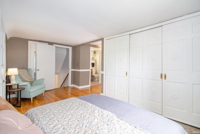 423 N Esther St, South Bend, IN 46617 - bedroom with wood finished floors, a closet, and ensuite bath