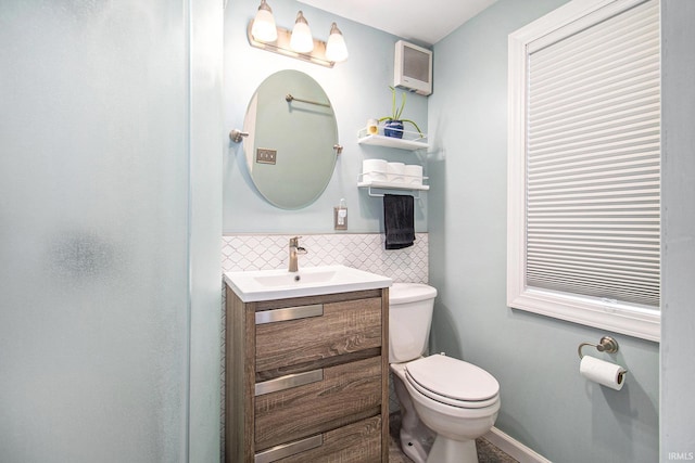 423 N Esther St, South Bend, IN 46617 - bathroom with toilet, vanity, and decorative backsplash