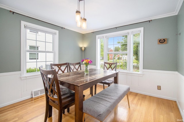 423 N Esther St, South Bend, IN 46617 - dining space with light wood-style flooring, ornamental molding, wainscoting, and baseboards