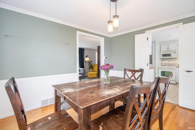 423 N Esther St, South Bend, IN 46617 - dining space with light wood-style flooring and crown molding