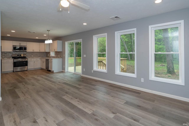 3214 Burr Oak Ave, Elkhart, IN 46517 - kitchen featuring stainless steel appliances, decorative backsplash, recessed lighting, baseboards, and light wood-style floors