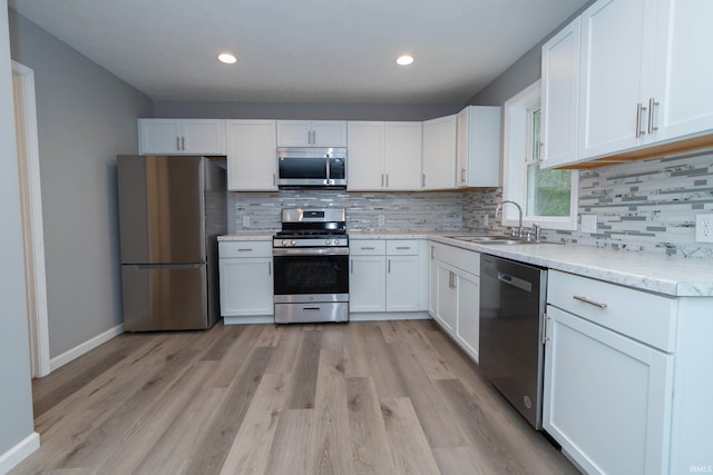3214 Burr Oak Ave, Elkhart, IN 46517 - kitchen featuring stainless steel appliances, a sink, white cabinetry, and recessed lighting