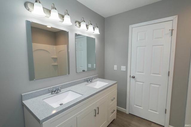 3214 Burr Oak Ave, Elkhart, IN 46517 - bathroom with wood finished floors, double vanity, and baseboards