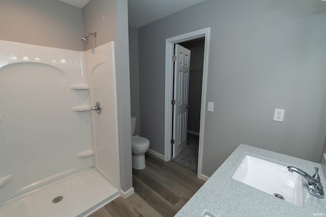 3214 Burr Oak Ave, Elkhart, IN 46517 - full bathroom featuring toilet, a shower stall, wood finished floors, baseboards, and vanity