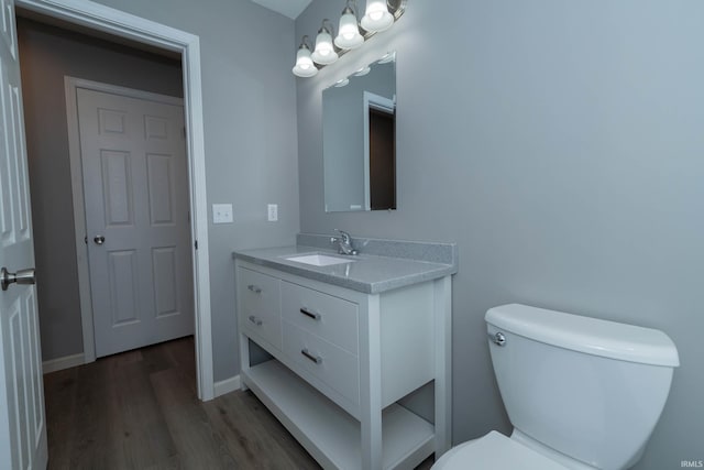 3214 Burr Oak Ave, Elkhart, IN 46517 - half bath with wood finished floors, toilet, vanity, and baseboards