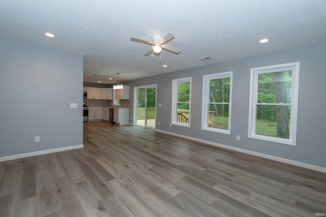 3214 Burr Oak Ave, Elkhart, IN 46517 - unfurnished living room with ceiling fan, recessed lighting, baseboards, and wood finished floors