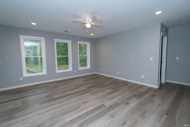 3214 Burr Oak Ave, Elkhart, IN 46517 - unfurnished room featuring plenty of natural light, ceiling fan, wood finished floors, baseboards, and recessed lighting