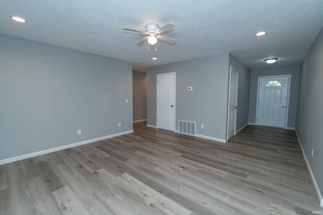 3214 Burr Oak Ave, Elkhart, IN 46517 - unfurnished living room featuring a ceiling fan, baseboards, light wood-style floors, and recessed lighting
